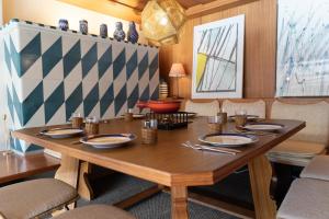 a dining room with a wooden table and chairs at Etienne in Wildhaus