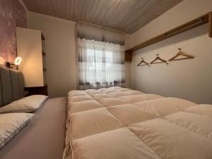 a row of beds in a room with a window at Astrid's Appartements in Winterberg