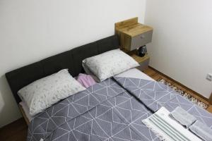 a bedroom with a bed with a black head board at Restart Apartment in Visoko +27 photos