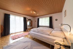 a bedroom with a large bed and two windows at Jambo Pua in Alt Sankt Johann