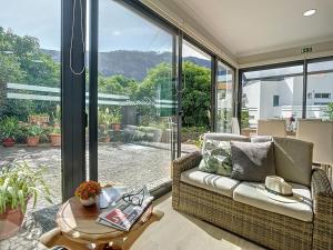 a living room with a couch and a table at Solarium Villa by Atlantic Holiday in Machico