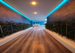 an empty hallway with blue lights on the wall at The Sunshine Otel & SPA in Istanbul