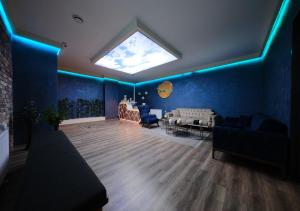 The Sunshine Otel & SPA في إسطنبول: غرفة معيشة بها المنور والجدران الزرقاء