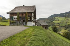 a house on the side of a grassy hill at Landhuus Toggi in Alt Sankt Johann