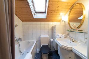 a bathroom with a tub and a toilet and a sink at Lisa in Wildhaus