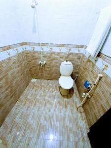 a bathroom with a toilet in a bath tub at Galaxy Inn in Karachi