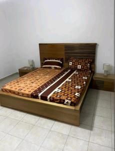 a large bed in a room with cookies on it at joli appart 2 chambres salon liberté 6 extension in Dakar