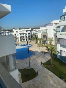 a view of a swimming pool from a building at Appartement de luxe ,piscine,parking,Terrasse in Agadir