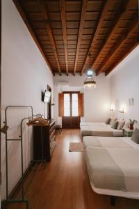 a large room with two beds and a couch at One & Lux Casa Maravilla in Seville
