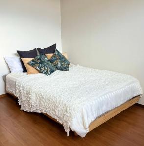 a bed with pillows on it in a room at Chateau TIIDA 国際通り徒歩5分 in Asato +32 photos