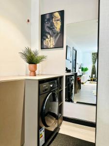 a laundry room with a washer and dryer at Escada Next level luxurious 1 bed home in Nairobi