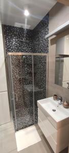 a bathroom with a shower and a sink at Gold Apartments Penthouse in Rzeszów