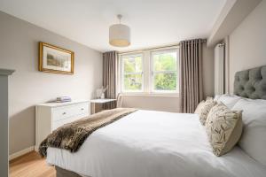 - une chambre avec 2 lits blancs et une fenêtre dans l'établissement Castle View Hideaway, à Édimbourg