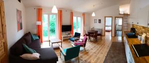 a living room with a couch and chairs at Ferienwohnung Blaue Sonne Devin in Stralsund