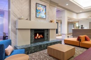 a living room with a fireplace and a couch at Hilton Garden Inn Montgomery East in Montgomery