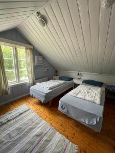 two beds in a room with a attic at Lofoten Budget Hostel in Å