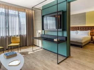 Ένα ή περισσότερα κρεβάτια σε δωμάτιο στο Pullman Santiago El Bosque
