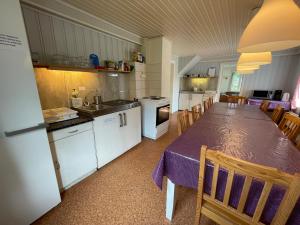 a kitchen with a table with a purple table cloth at Lofoten Budget Hostel in Å