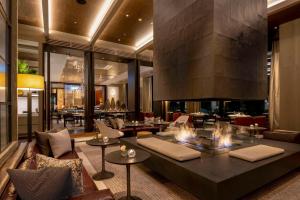 a lobby with a couch and chairs and tables at Park Hyatt Niseko Hanazono in Niseko