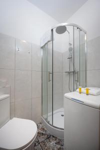 a bathroom with a shower and a toilet and a tub at Park Praski Standard Studio in Warsaw