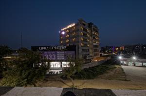 a one centre building at night with lights on at HOTEL AURELLIA in Sarkhej