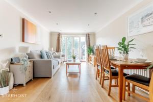 a living room with a couch and a table at StarHost Residences - Modern 2 bed apartment at Imperial Court, Newbury in Newbury