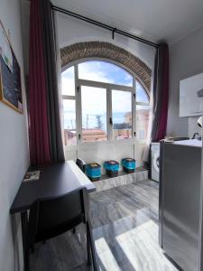 a kitchen with a table and a large window at Casa Viola - Al Centro in Taormina