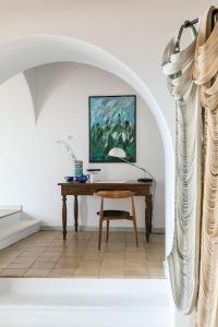 a desk in a room with a painting on the wall at Albergo Il Monastero in Ischia