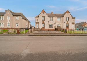 an empty street in front of a large house at McCulloch Apartment by Klass Living Uddingston in Uddingston