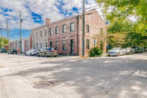 an empty street with cars parked in front of a brick building at Newly Renovated Downtown Apartment in the Historic District, Quiet Street! in Mobile