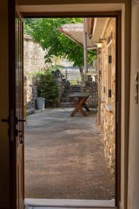 an open door to a patio with a picnic table at Taygeti's mountain lodge in Sparti