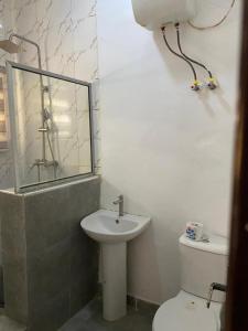 a bathroom with a white toilet and a sink at Christmas Promo-Time in Wupa