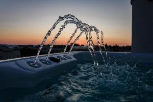 a hot tub with water coming out of it at Villa Miri III in Privlaka