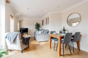 a dining room and living room with a table and chairs at StarHost Residences - Smart 2 Bedroom Apartment in Newbury in Newbury