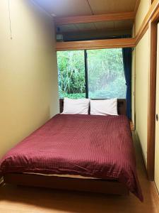 Postel nebo postele na pokoji v ubytování シークレットベースゆふいん