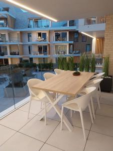 a wooden table and chairs on a balcony at Sailors' Park Villa Zephir in Nieuwpoort