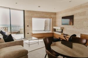 a living room with a couch and a table at Clifftops Lodge in Portland