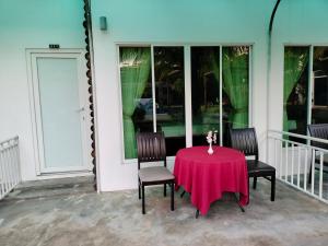 a table with two chairs and a red table cloth at Twin Palms Resort in Sihanoukville