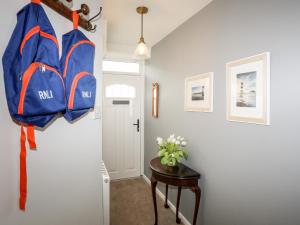 a hallway with two blue bags hanging on a wall at Silva in Penmon