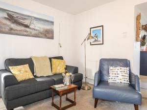 a living room with a couch and a chair at Silva in Penmon