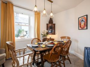 a dining room with a table and chairs at Silva in Penmon +36 photos