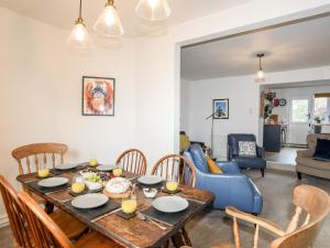a dining room and living room with a table and chairs at Silva in Penmon