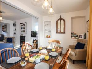 a living room with a wooden table and chairs at Silva in Penmon