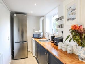 a kitchen with a stainless steel refrigerator and a sink at Silva in Penmon