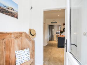 a hallway with a door leading to a kitchen at Silva in Penmon