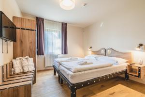 A bed or beds in a room at Hotel Resort Relax