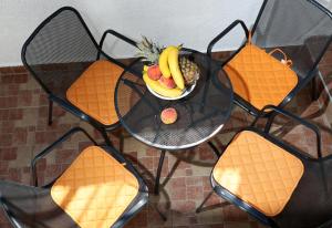 a plate of fruit on a table with chairs at Luxury Lidija Rooms in Split +42 photos