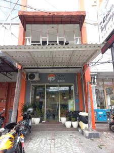 a store front with motorcycles parked in front of it at The Cabin Tanjung Yogyakarta in Yogyakarta