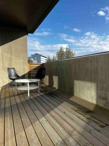 a patio with a chair and a table on a deck at Stay Iceland apartments - G 1 in Reykjavík