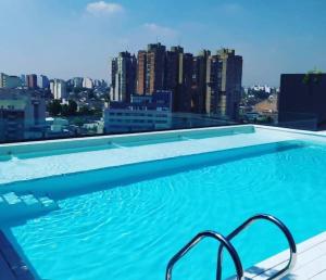 a swimming pool with a view of a city at Departamento alquiler temporal in Buenos Aires